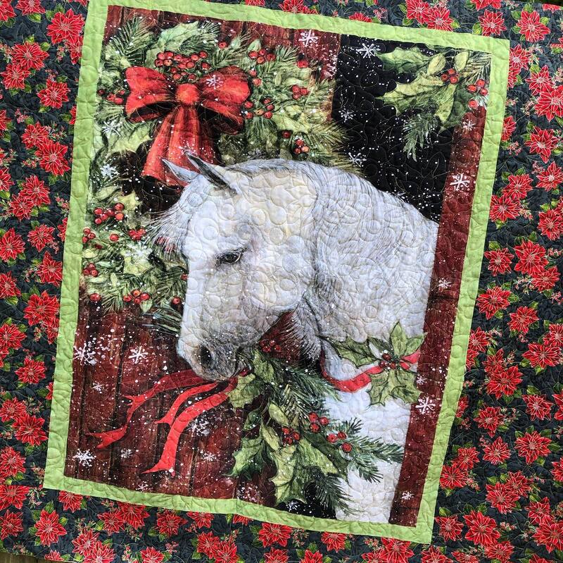 A horse panel makes a perfect backing for a Christmas quilt, machine quilted by Amy Martin of Peaceful Quilts located in Lafayette Indiana. 