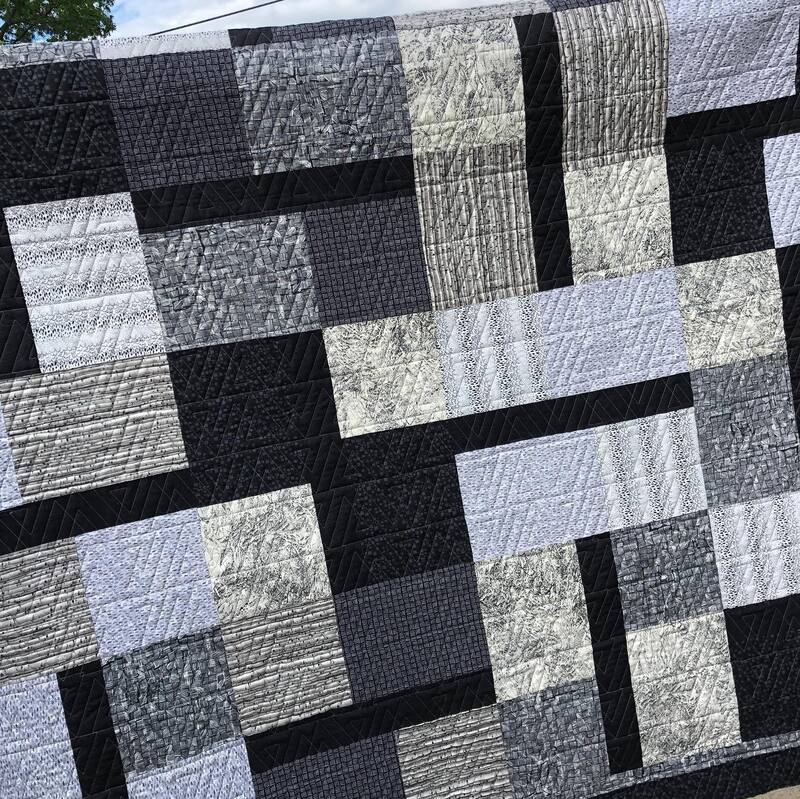 A modern black and great quilt, machine quilted by Amy Martin of Peaceful Quilts in Lafayette Indiana