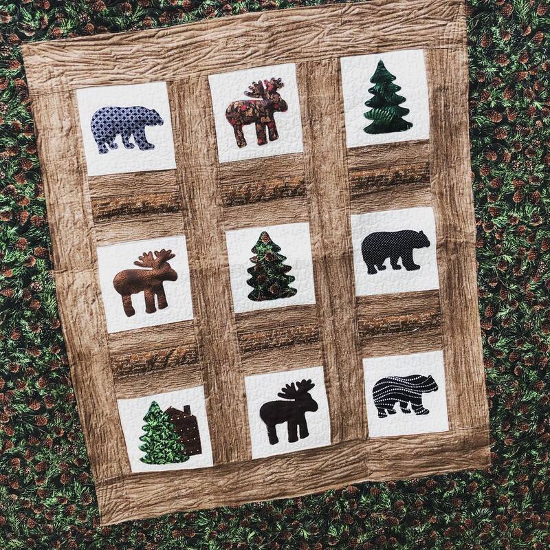 A Christmas applique window quilt, machine quilted by Amy Martin of Peaceful Quilts in Lafayette Indiana
