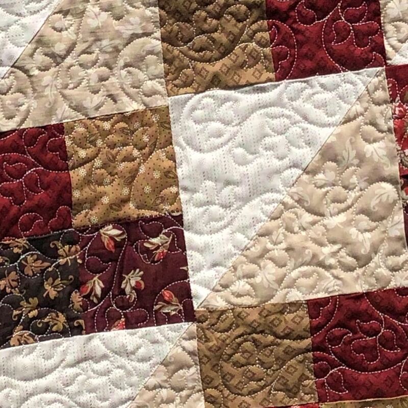 Blooming hearts on a classic quilt in fall colors, machine quilted by Amy Martin of Peaceful Quilts in Lafayette Indiana