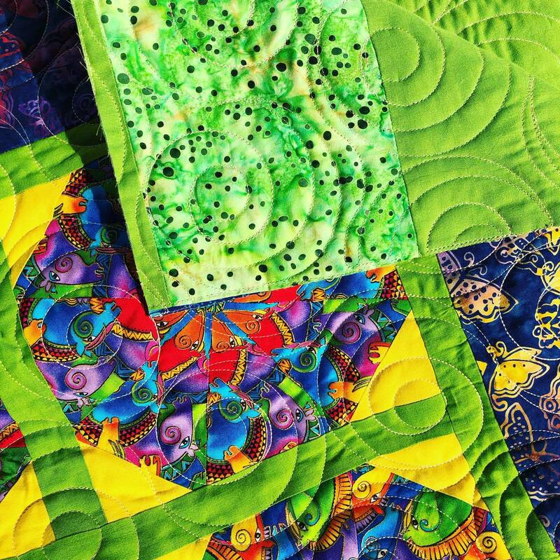 A bright, modern quilt machine quilted by Amy Martin of Peaceful Quilts in Lafayette Indiana
