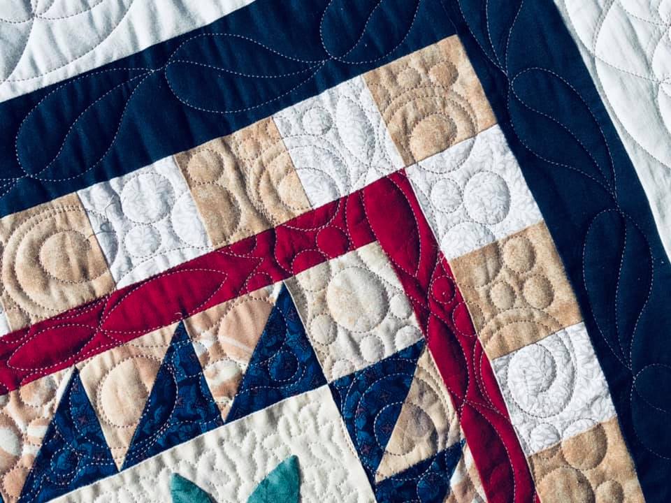 Custom borders on a round robin quilt custom quilted by Amy Martin of Peaceful Quilts in Lafayette Indiana