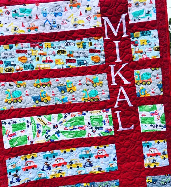 A personalized baby quilt with name applique, pieced and machine quilted by Amy Martin of Peaceful Quilts in Lafayette Indiana