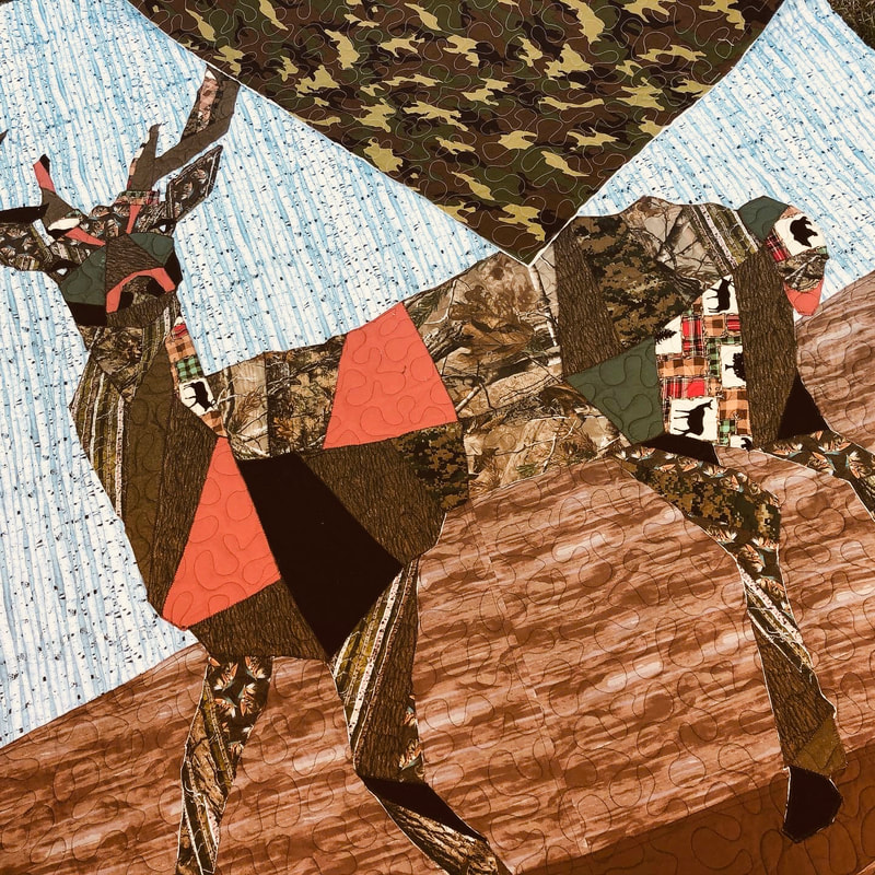 An applique deer is featured on this quilt longarmed by Amy Martin of Peaceful Quilts of Lafayette Indiana